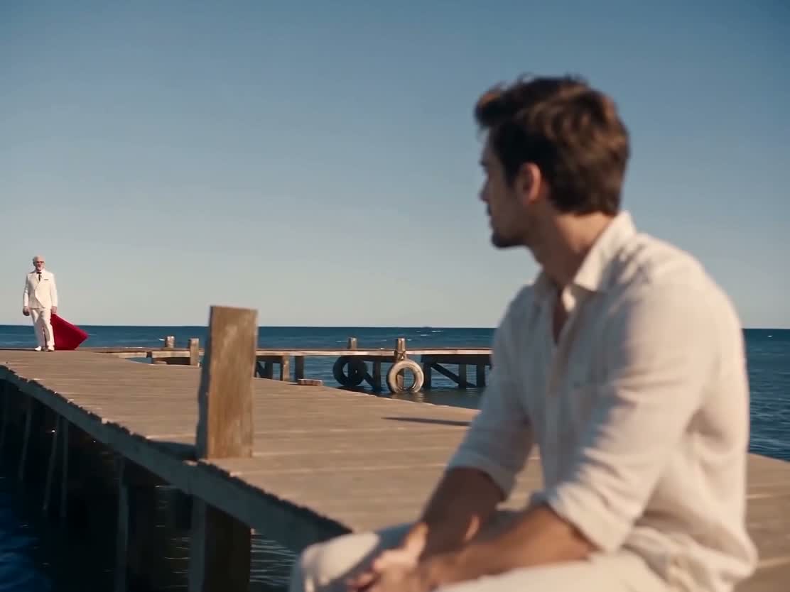 Mini test at 2.5 seconds: the foreground man changed, but a white-haired suited performer with a red cape remains in the distance